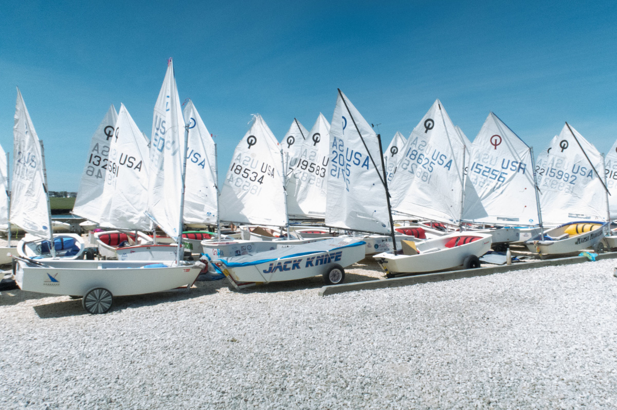 Sailboats-lined-up-on-rocky-beach-JUNIOR-SAILING-Avalon-Yacht-Club