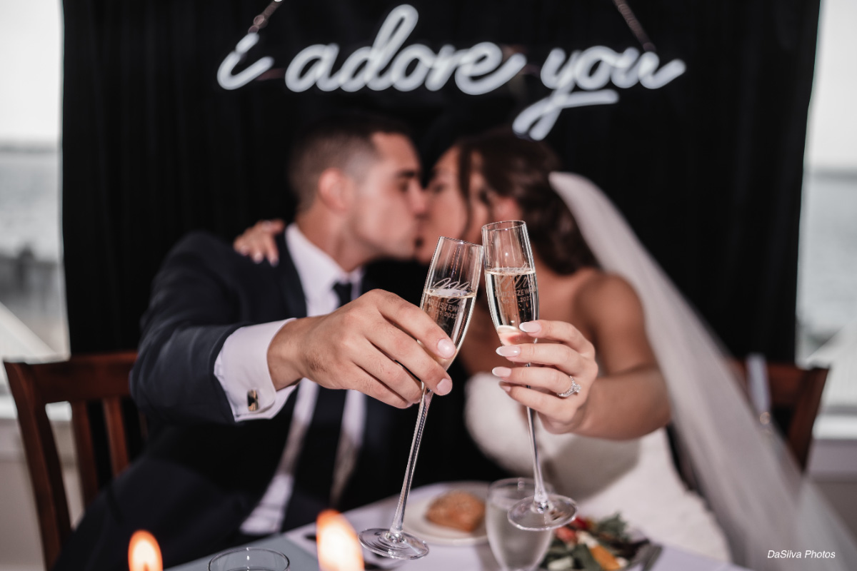 newlyweds-toasting-champagne-at-wedding-WEDDING-&-EVENTS-Ballroom-Table-decor-Avalon-Yacht-Club